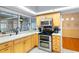 Modern kitchen featuring stainless steel appliances, wood cabinets and natural light at 6143 Black Walnut Dr, Bartow, FL 33830