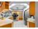 Spacious kitchen with stainless steel appliances, white tile floors, and oak cabinets at 6143 Black Walnut Dr, Bartow, FL 33830