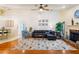 Bright living room with hardwood floors, a ceiling fan, and a view into the dining room at 6143 Black Walnut Dr, Bartow, FL 33830