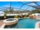 Sparkling pool and spa are enclosed, with mature landscaping and a waterfall feature at 6143 Black Walnut Dr, Bartow, FL 33830