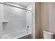 Bright bathroom features a white tiled shower-tub combination and modern fixtures at 742 Ambleside Dr, Haines City, FL 33844