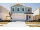 Charming two-story home featuring a two-car garage and colorful exterior paint at 742 Ambleside Dr, Haines City, FL 33844