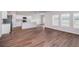 Large kitchen and living room with wood flooring and windows with blinds at 742 Ambleside Dr, Haines City, FL 33844