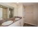 Bathroom with dual sinks, spacious mirror, and shower at 770 Ambleside Dr, Haines City, FL 33844