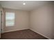 Carpeted bedroom featuring a window and a light fixture at 770 Ambleside Dr, Haines City, FL 33844