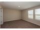 Well-lit bedroom with soft carpet and double windows at 770 Ambleside Dr, Haines City, FL 33844