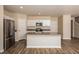 Well-lit kitchen with a center island, stainless steel appliances, and wood flooring throughout at 770 Ambleside Dr, Haines City, FL 33844