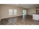Large living room featuring wood floors and sliding glass doors leading to the outdoor space at 770 Ambleside Dr, Haines City, FL 33844