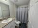 Bathroom featuring a sink with granite countertops, a toilet, and a shower with gray curtain at 1368 Axel Cir, Winter Haven, FL 33880