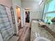 Bathroom featuring double sinks with granite countertops, a separate toilet area, and a walk-in closet at 1368 Axel Cir, Winter Haven, FL 33880