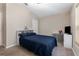 Bedroom with neutral walls and carpet, featuring a comfortable blue quilted bedspread at 1368 Axel Cir, Winter Haven, FL 33880