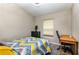 Bedroom with stylish bedspread, window, desk and chair; creating a comfortable space at 1368 Axel Cir, Winter Haven, FL 33880