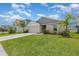 Charming single-story home with well-maintained lawn, two-car garage and mature palm trees at 1368 Axel Cir, Winter Haven, FL 33880