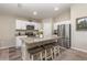 Bright kitchen with granite countertops, white cabinets, stainless steel appliances and breakfast bar at 1368 Axel Cir, Winter Haven, FL 33880