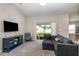 Cozy living room with plush gray sectional sofa, stylish blue cabinet, and natural light at 1368 Axel Cir, Winter Haven, FL 33880