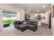 Open-concept living room featuring a gray sofa and a view of the adjacent kitchen at 1368 Axel Cir, Winter Haven, FL 33880