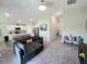 Cozy living room featuring a gray sectional sofa adjacent to the modern kitchen at 1368 Axel Cir, Winter Haven, FL 33880