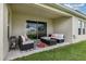 Covered patio with stylish seating area, creating an inviting outdoor space at 1368 Axel Cir, Winter Haven, FL 33880