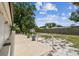 Large, serene back yard with green grass, mature trees, fire pit, and shed for extra storage at 229 Temple Ave, Fern Park, FL 32730