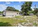 Expansive back yard with fire pit, white cinderblock home, and storage shed at 229 Temple Ave, Fern Park, FL 32730