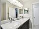 The updated bathroom offers dual sinks with white marble counters, modern fixtures, and recessed lighting at 229 Temple Ave, Fern Park, FL 32730