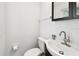 The half bathroom includes a dark wood vanity, a white sink, modern faucet, and a toilet at 229 Temple Ave, Fern Park, FL 32730