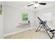 A bedroom shows a ceiling fan, white walls, tiled floors, two windows, and an inversion table at 229 Temple Ave, Fern Park, FL 32730