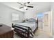 This bright bedroom features a ceiling fan, two windows, a comfortable bed, and tiled floors at 229 Temple Ave, Fern Park, FL 32730