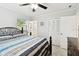 The bedroom showcases a ceiling fan, a large bed, tiled floors, and ample closet space at 229 Temple Ave, Fern Park, FL 32730
