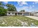 Charming single-story home with a well-maintained lawn and attached two car garage and freshly painted white brick at 229 Temple Ave, Fern Park, FL 32730