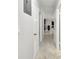 A hallway displays a tiled floor, neutral walls, and white trim with access to other rooms at 229 Temple Ave, Fern Park, FL 32730