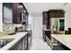 This updated kitchen shows granite countertops, stainless appliances, and dark wood cabinetry at 229 Temple Ave, Fern Park, FL 32730