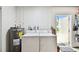 Bright laundry area includes washer, dryer, and convenient access to the outdoors at 229 Temple Ave, Fern Park, FL 32730
