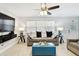 Inviting living room featuring a comfortable sofa, a large window with blinds, and a ceiling fan and lighting fixture at 229 Temple Ave, Fern Park, FL 32730