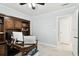 This office has a built-in wooden desk and shelves with a tiled floor and white walls at 229 Temple Ave, Fern Park, FL 32730