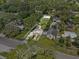 Aerial view of the property showcases the spacious lot surrounded by mature trees at 306 Avenue A E, Winter Haven, FL 33880
