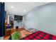 Bright bedroom features wood floor, mounted TV and blue accent wall at 306 Avenue A E, Winter Haven, FL 33880
