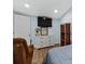 Well-lit bedroom with dresser, television, and closet at 306 Avenue A E, Winter Haven, FL 33880