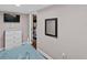 Cozy bedroom with TV, mirror, and blue bedding at 306 Avenue A E, Winter Haven, FL 33880