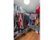 Walk-in closet with shelving, hanging racks, and wood floor at 306 Avenue A E, Winter Haven, FL 33880