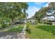 Quaint single-story home with well-maintained lawn, inviting walkway, and decorative plants at 306 Avenue A E, Winter Haven, FL 33880