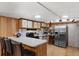 Functional kitchen with white countertops, modern appliances, bar stool seating and wood paneling at 306 Avenue A E, Winter Haven, FL 33880