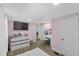 Bright bedroom with white furniture, mounted TV, pink walls, and wood-look flooring at 306 Avenue A E, Winter Haven, FL 33880