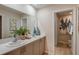 Bathroom with double sinks, white countertops, neutral cabinets, and framed art piece at 3759 King Hill Dr, Haines City, FL 33844