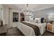 Elegant bedroom featuring a plush bed, stylish chandelier, and serene decor at 3759 King Hill Dr, Haines City, FL 33844