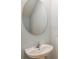 Simple powder room featuring a contemporary oval mirror and faucet set at 3759 King Hill Dr, Haines City, FL 33844
