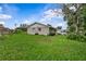 Side view of home with a well-maintained lawn, showcasing the property's exterior at 4003 Prairie Bend Ln, Lakeland, FL 33812