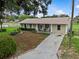 Lovely home featuring a well-manicured front lawn, inviting rocking chairs on the porch, and a long driveway at 4003 Prairie Bend Ln, Lakeland, FL 33812