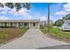 Quaint home showcasing a well-kept lawn, tidy landscaping and a welcoming front porch at 4003 Prairie Bend Ln, Lakeland, FL 33812