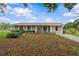 Charming home with lush front yard, showcasing its well-maintained landscaping and curb appeal at 4003 Prairie Bend Ln, Lakeland, FL 33812